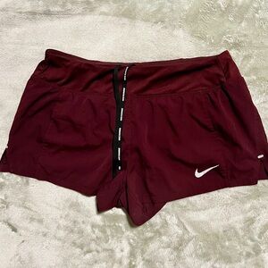 Nike Red Athletic Shorts with Lightweight Fabric and White Logo